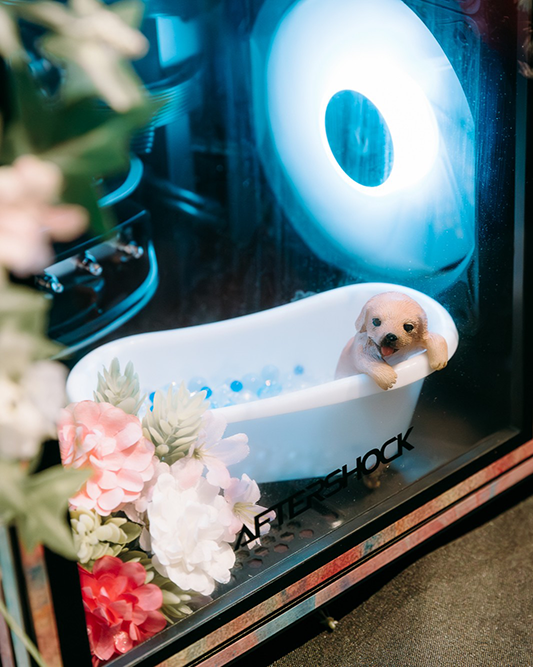 Photo of a dog figurine in a bathtub, inside a PC case